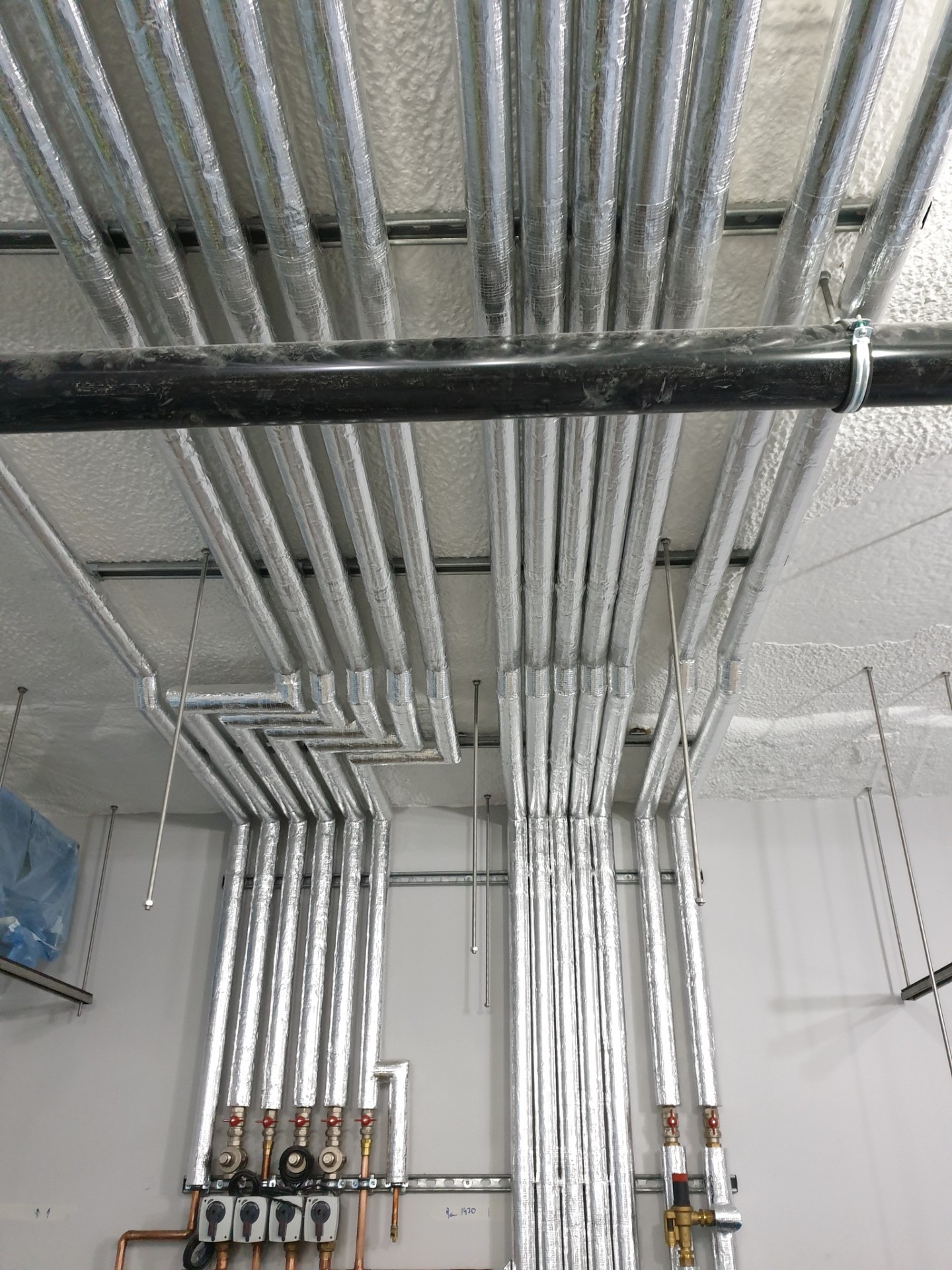 Commercial insulated pipework installation with copper runs and valves