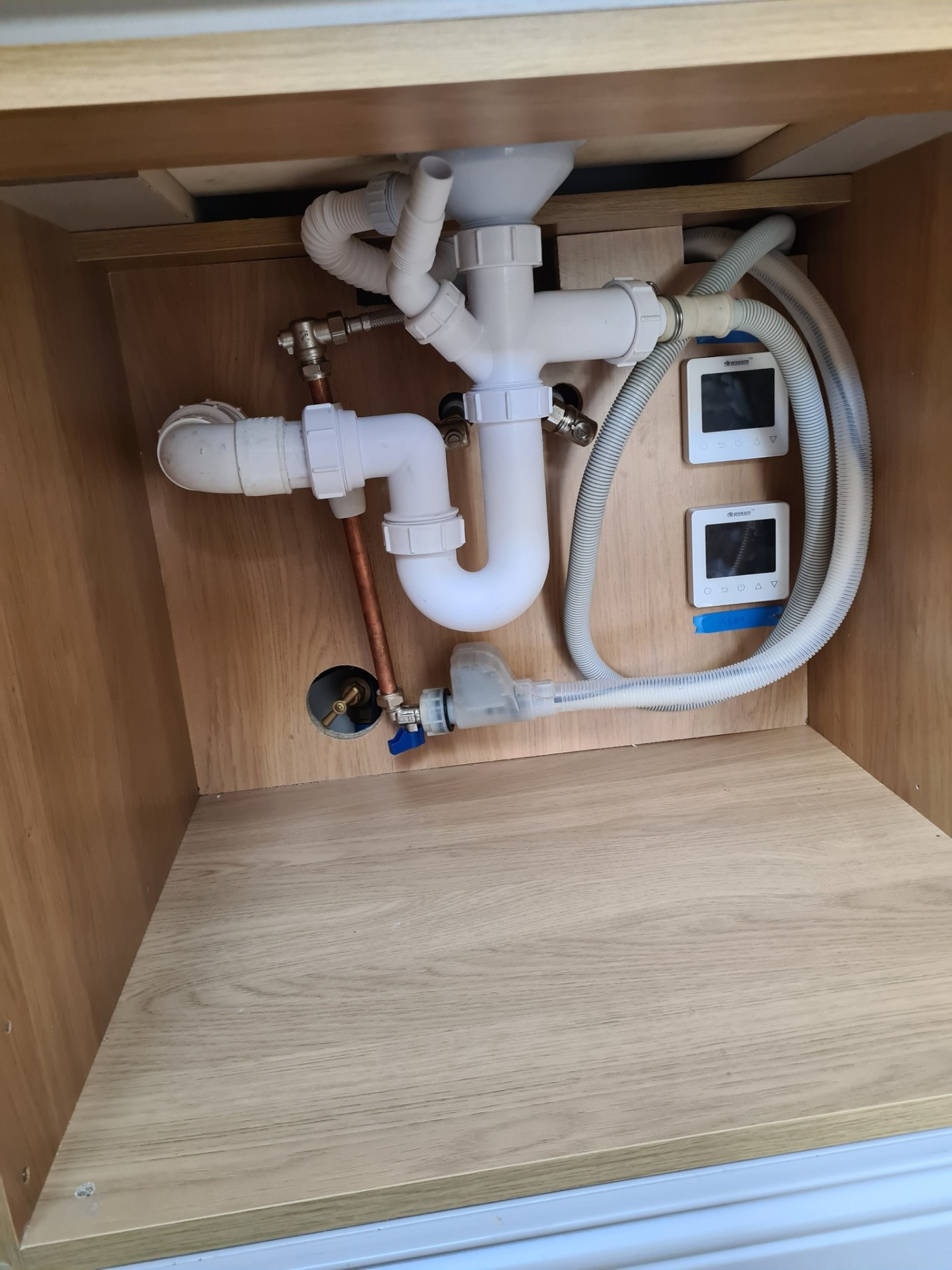 Under-sink plumbing pipework with copper and plastic waste connections